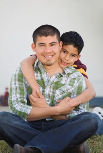 Happy family sitting together on grass