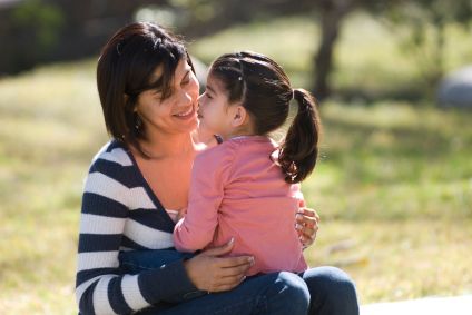Mother and daughter embracing outdoors